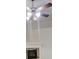 A stone fireplace is situated below a ceiling fan at 900 Ellesmere Pt, Mcdonough, GA 30253