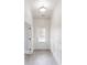 Well-lit hallway with white trim, light wood floors, and a glass-paneled back door for natural light at 900 Ellesmere Pt, Mcdonough, GA 30253