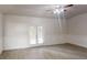 Living room with wood floors, detailed wainscoting, and double glass doors to the outside at 900 Ellesmere Pt, Mcdonough, GA 30253