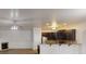 Spacious living room featuring a fireplace and hardwood floors adjacent to a kitchen with an eat-in breakfast bar at 900 Ellesmere Pt, Mcdonough, GA 30253