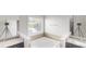 Bathroom with granite counters, soaking tub, and separate vanity at 900 Ellesmere Pt, Mcdonough, GA 30253