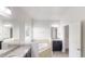 Bathroom with double vanity, soaking tub, separate shower, and large mirror at 900 Ellesmere Pt, Mcdonough, GA 30253