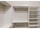 A view of the walk-in closet, showcasing white adjustable shelving and chrome bars at 900 Ellesmere Pt, Mcdonough, GA 30253