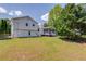 Expansive backyard featuring a screened porch, white fencing, and a lush green lawn at 2584 Gravitt Rd, Duluth, GA 30096