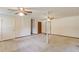 Carpeted living room featuring multiple ceiling fans, closets, and an exposed column at 2584 Gravitt Rd, Duluth, GA 30096