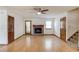 Cozy living room featuring a brick fireplace, ceiling fan, and hardwood floors at 2584 Gravitt Rd, Duluth, GA 30096