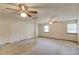 Spacious carpeted living room with three ceiling fans, lots of closet space, and natural light at 2584 Gravitt Rd, Duluth, GA 30096