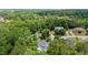 Beautiful aerial view of the house nestled amongst lush green trees and landscaping in a quiet neighborhood at 3014 Volland Grove Trail, Lawrenceville, GA 30043