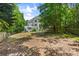 Large, level backyard surrounded by mature trees and a wooden fence offering privacy and space for recreation at 3014 Volland Grove Trail, Lawrenceville, GA 30043