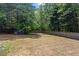 Expansive backyard enclosed by a wooden fence, surrounded by mature trees for added privacy at 3014 Volland Grove Trail, Lawrenceville, GA 30043