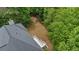 Aerial view of the backyard featuring trees, grass, and a deck at 3014 Volland Grove Trail, Lawrenceville, GA 30043