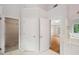 Bright bathroom with tiled floors, a vanity, and access to a walk-in closet and a bedroom at 3014 Volland Grove Trail, Lawrenceville, GA 30043