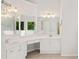 Elegant bathroom featuring dual sinks, vanity, and a window overlooking greenery at 3014 Volland Grove Trail, Lawrenceville, GA 30043