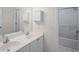 Bright bathroom features double sinks with white cabinets and a shower with tub at 3014 Volland Grove Trail, Lawrenceville, GA 30043