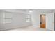 This bright bedroom features neutral carpet, two windows, and an open door at 3014 Volland Grove Trail, Lawrenceville, GA 30043