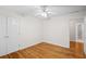 This bedroom offers beautiful hardwood floors, a ceiling fan, neutral walls, and a closet for storage at 3014 Volland Grove Trail, Lawrenceville, GA 30043