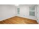 Bright bedroom features two windows, a ceiling fan, and hardwood floors at 3014 Volland Grove Trail, Lawrenceville, GA 30043