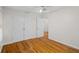 Bedroom features hardwood floors, closet, and ceiling fan at 3014 Volland Grove Trail, Lawrenceville, GA 30043