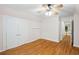 Bedroom features hardwood floors, a ceiling fan, and a closet at 3014 Volland Grove Trail, Lawrenceville, GA 30043