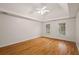 Cozy bedroom with a tray ceiling, ceiling fan, hardwood floors, and dual windows for ample sunlight at 3014 Volland Grove Trail, Lawrenceville, GA 30043