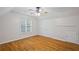 Bedroom features hardwood floors, a ceiling fan, and double closets at 3014 Volland Grove Trail, Lawrenceville, GA 30043