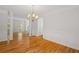 Open dining area with hardwood floors, wainscoting, and decorative chandelier at 3014 Volland Grove Trail, Lawrenceville, GA 30043