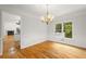 Elegant dining room featuring hardwood floors, a chandelier, and large window at 3014 Volland Grove Trail, Lawrenceville, GA 30043