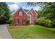 Beautiful brick home with black shutters, green lawn, and well-manicured landscaping at 3014 Volland Grove Trail, Lawrenceville, GA 30043