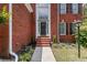 Inviting front entrance with brick steps and arched window feature above the door at 3014 Volland Grove Trail, Lawrenceville, GA 30043