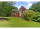 Spacious brick home on a large lot, surrounded by mature trees and greenery at 3014 Volland Grove Trail, Lawrenceville, GA 30043