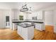 Bright kitchen featuring white cabinets, black countertops, stainless steel appliances, and eat-in breakfast area at 3014 Volland Grove Trail, Lawrenceville, GA 30043