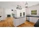 Spacious kitchen with white cabinets, black countertops, stainless steel appliances, and views to living room at 3014 Volland Grove Trail, Lawrenceville, GA 30043