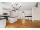 Gourmet kitchen features island and breakfast nook, white cabinets, and an open-concept floor plan at 3014 Volland Grove Trail, Lawrenceville, GA 30043