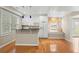 Updated kitchen with white cabinets, modern appliances, and breakfast bar, with hardwood floors at 3014 Volland Grove Trail, Lawrenceville, GA 30043