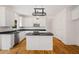 Updated kitchen with white cabinets, stainless appliances, a central island, and black countertops at 3014 Volland Grove Trail, Lawrenceville, GA 30043