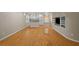 Living room featuring hardwood floors, kitchen area, built-in shelving, and access to the backyard at 3014 Volland Grove Trail, Lawrenceville, GA 30043