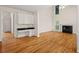 Spacious living room featuring fireplace, hardwood floors, and built-in desk with wall cabinets at 3014 Volland Grove Trail, Lawrenceville, GA 30043