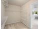 Well-organized walk-in closet with multiple shelves and a doorway leading to the bathroom at 3014 Volland Grove Trail, Lawrenceville, GA 30043