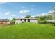 Spacious backyard with a gentle slope, lush green grass, and mature trees in the background at 3757 Cindy Dr, Douglasville, GA 30135
