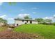 Expansive backyard featuring a lush green lawn, gentle slope, and mature trees at 3757 Cindy Dr, Douglasville, GA 30135