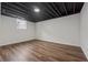 Empty basement with hardwood floors and a small window for natural light at 3757 Cindy Dr, Douglasville, GA 30135