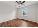 Bright bedroom featuring hardwood floors, ceiling fan and a large window at 3757 Cindy Dr, Douglasville, GA 30135
