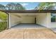 Spacious carport featuring white brick, a painted floor, and access to an interior door at 3757 Cindy Dr, Douglasville, GA 30135