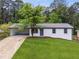 Charming home with a freshly painted exterior, well-manicured lawn, and convenient carport at 3757 Cindy Dr, Douglasville, GA 30135
