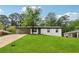Inviting exterior with a lush green lawn, mature tree, and a convenient covered carport at 3757 Cindy Dr, Douglasville, GA 30135