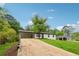 Lovely home featuring a long driveway, well-kept lawn, and a convenient carport at 3757 Cindy Dr, Douglasville, GA 30135