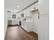 Stylish kitchen featuring ample white cabinetry, stainless steel appliances, and modern wood-look flooring at 3757 Cindy Dr, Douglasville, GA 30135