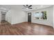 Bright, open-concept living room with wood flooring, a ceiling fan, and a large window offering plenty of natural light at 3757 Cindy Dr, Douglasville, GA 30135