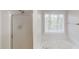 Close up of soaking tub with jets and shower with window at 4912 Lightwood Nw Ct, Acworth, GA 30102