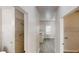 Hallway between a full bathroom and laundry room with views into the kitchen at 4912 Lightwood Nw Ct, Acworth, GA 30102